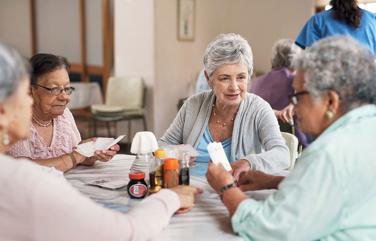 group of senior women playing cards